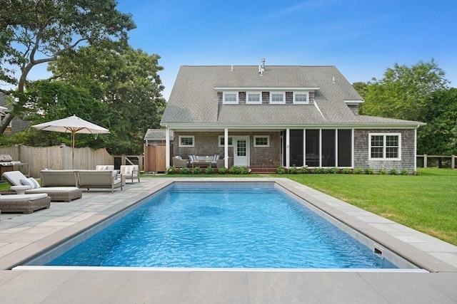 back of property with outdoor lounge area, a patio, and a sunroom