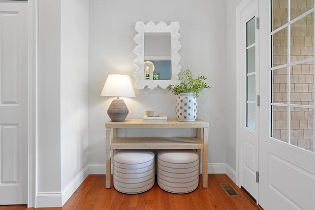 entryway with wood finished floors and baseboards