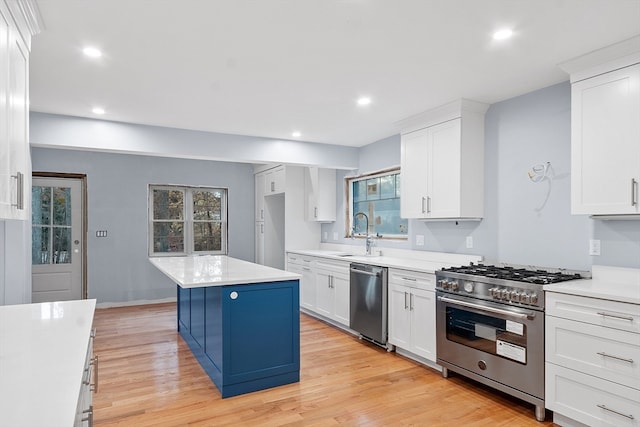 kitchen with white cabinetry, a center island, sink, and appliances with stainless steel finishes