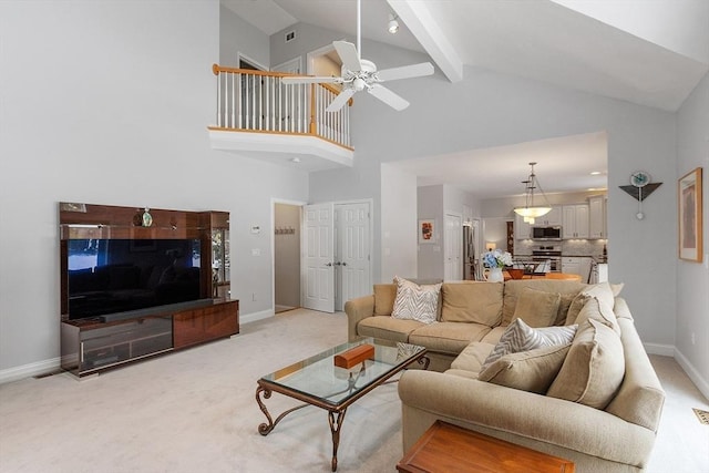 living room with ceiling fan, beam ceiling, high vaulted ceiling, and light carpet