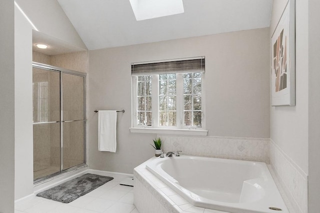 bathroom featuring tile patterned floors, plus walk in shower, and vaulted ceiling with skylight