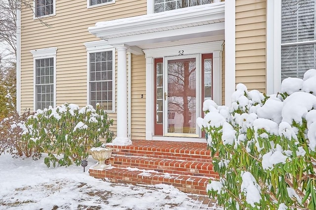 view of snow covered property entrance