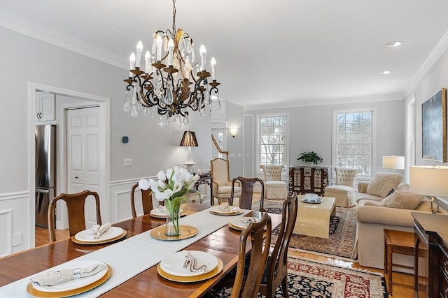 dining area featuring ornamental molding and an inviting chandelier