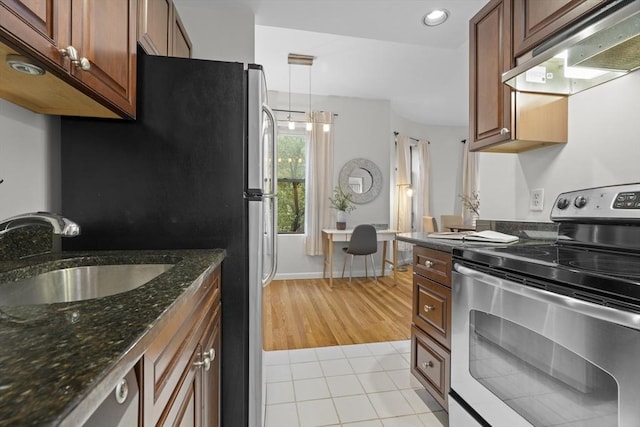 kitchen with stainless steel electric stove, a sink, custom range hood, light tile patterned floors, and recessed lighting