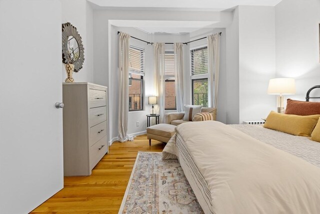 bedroom with light wood-style floors and baseboards