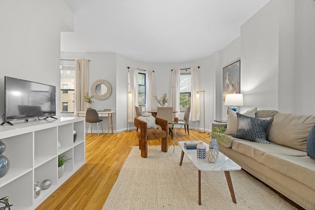 living area with light wood-style floors and baseboards