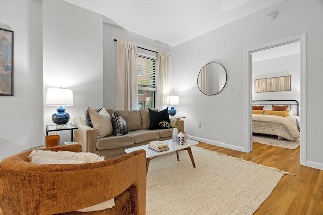 living area featuring light wood finished floors and baseboards