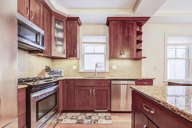 19 Harris St Unit 2, Brookline, MA 02446 - kitchen featuring stainless steel appliances, a sink, plenty of natural light, and light stone countertops