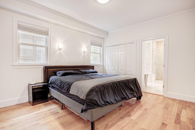 19 Harris St Unit 2, Brookline, MA 02446 - bedroom with ornamental molding, baseboards, light wood finished floors, and a closet