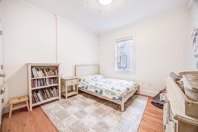 19 Harris St Unit 2, Brookline, MA 02446 - bedroom with light wood-type flooring, crown molding, and baseboards