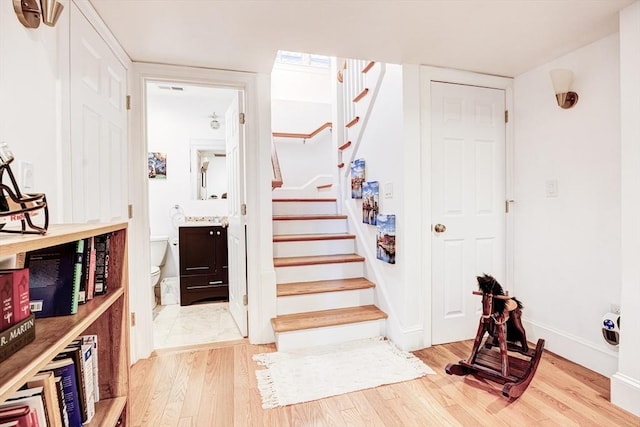19 Harris St Unit 2, Brookline, MA 02446 - stairs featuring wood finished floors and baseboards