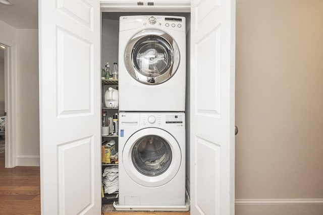 19 Harris St Unit 2, Brookline, MA 02446 - washroom featuring stacked washer and clothes dryer, wood finished floors, and baseboards