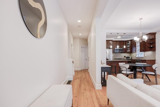 19 Harris St Unit 2, Brookline, MA 02446 - hall featuring a chandelier, light wood-style flooring, recessed lighting, baseboards, and ornamental molding