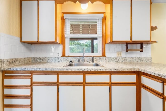 76 N Main St, Bellingham, MA 02019 - kitchen featuring a sink, light countertops, white cabinets, and decorative backsplash