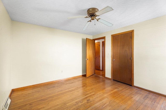 76 N Main St, Bellingham, MA 02019 - unfurnished room with a baseboard radiator, light wood-style flooring, baseboards, and ceiling fan