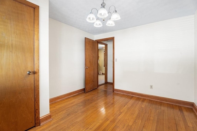 76 N Main St, Bellingham, MA 02019 - unfurnished room with a chandelier, baseboards, and light wood finished floors