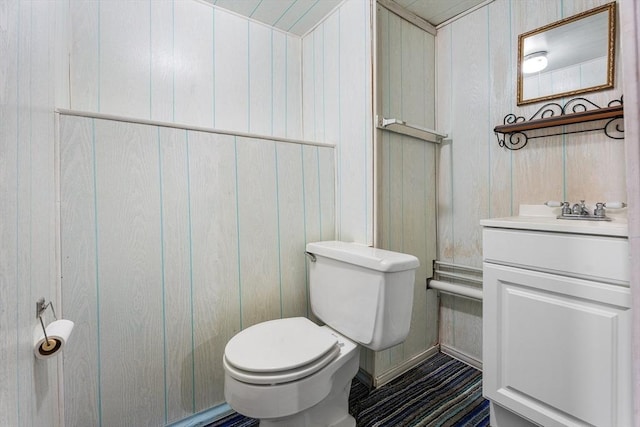 76 N Main St, Bellingham, MA 02019 - half bathroom featuring toilet, vanity, and wood walls