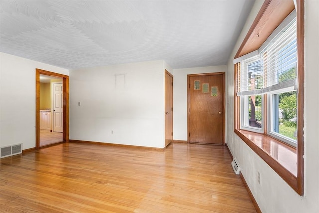 76 N Main St, Bellingham, MA 02019 - empty room with baseboards and light wood-style floors