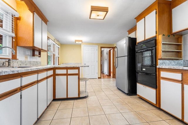 76 N Main St, Bellingham, MA 02019 - kitchen with freestanding refrigerator, black oven, a warming drawer, light countertops, and decorative backsplash