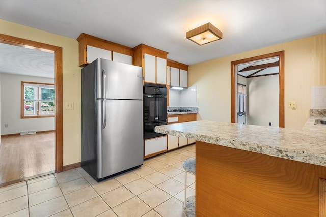 76 N Main St, Bellingham, MA 02019 - kitchen with freestanding refrigerator, oven, light countertops, and a warming drawer