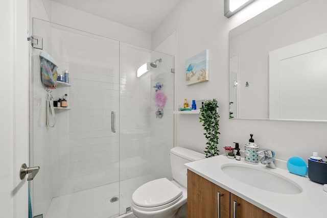full bath with toilet, vanity, and a shower stall