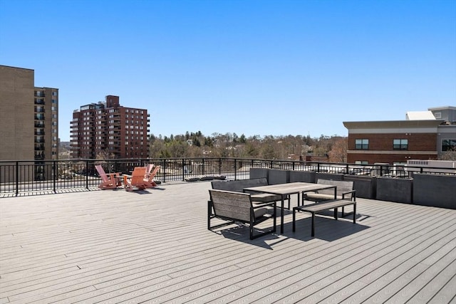 wooden terrace featuring outdoor dining area