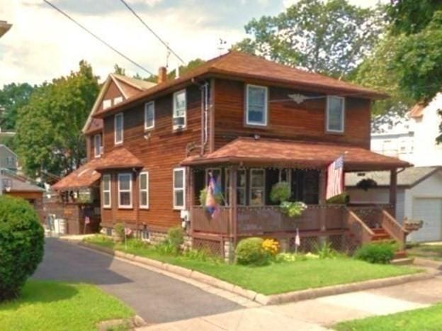 view of front of home with covered porch and a garage