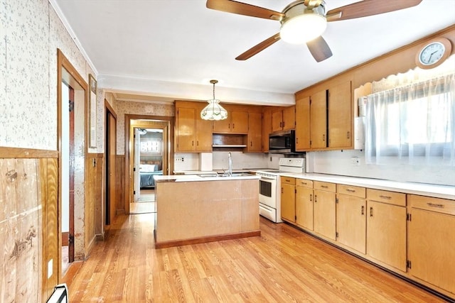 kitchen featuring a center island, light wood-type flooring, electric range, pendant lighting, and ceiling fan