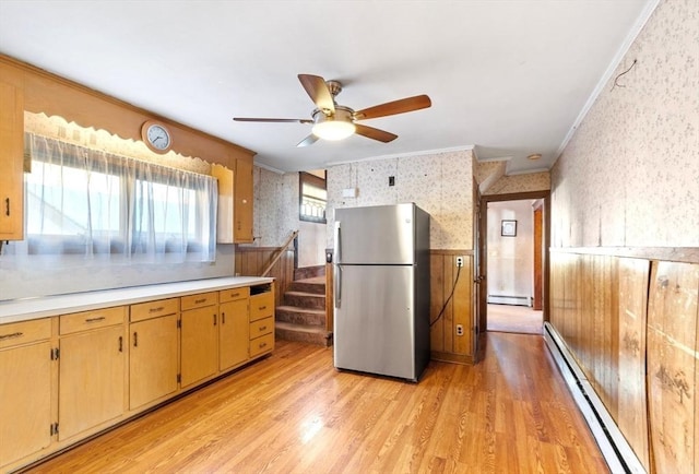 kitchen featuring light hardwood / wood-style floors, stainless steel refrigerator, ornamental molding, and baseboard heating