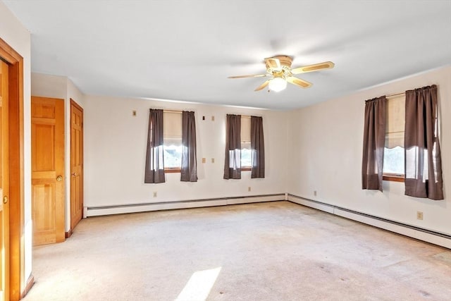 unfurnished room with ceiling fan, a baseboard radiator, and light carpet