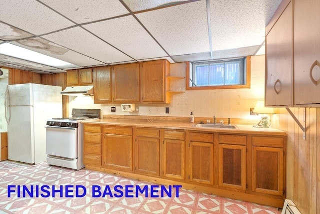 kitchen with sink, white appliances, a paneled ceiling, and a baseboard radiator