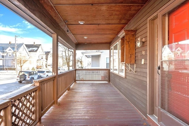 snow covered deck with a porch