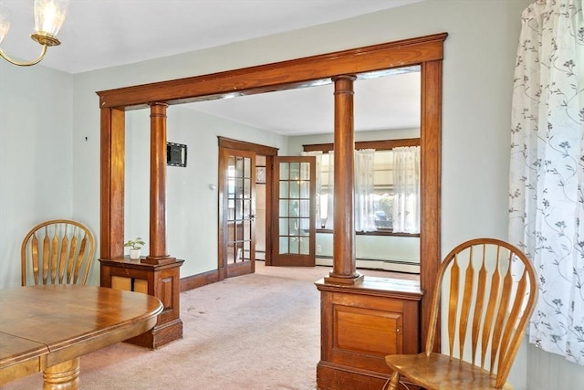 sitting room with french doors, light colored carpet, and ornate columns