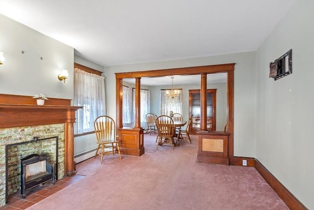 sitting room featuring a fireplace, baseboard heating, carpet, and an inviting chandelier