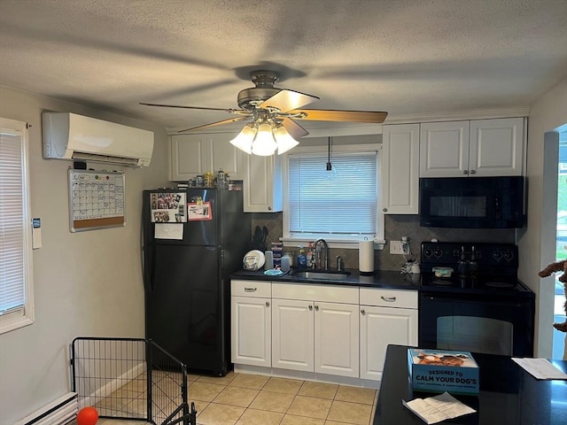 kitchen featuring a wall unit AC, light tile patterned floors, black appliances, white cabinetry, and sink