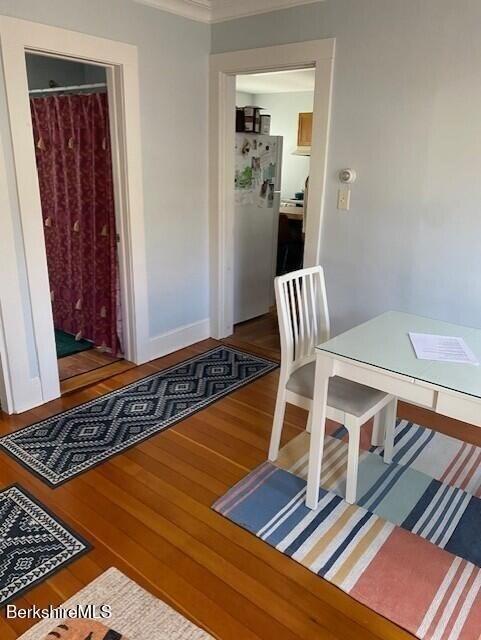 dining room with crown molding and hardwood / wood-style flooring