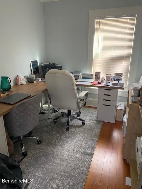 home office with hardwood / wood-style floors