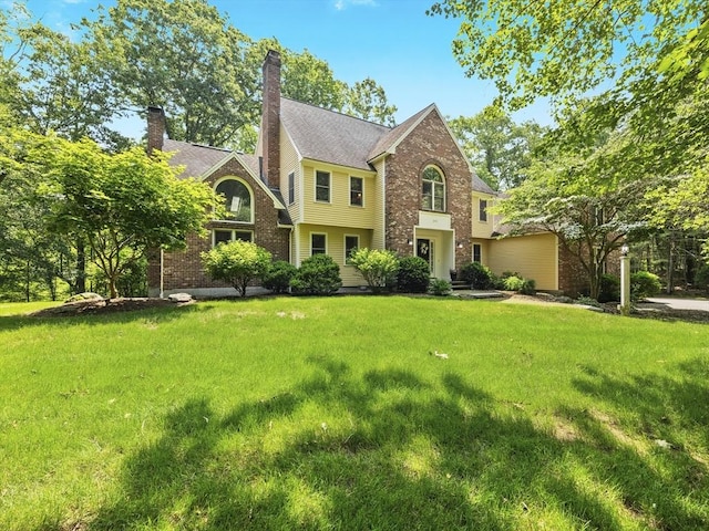 200 Newtown Rd, Acton, MA 01720 - view of front of house with a front yard, brick siding, and a chimney
