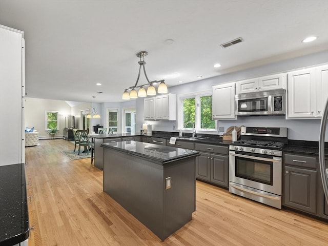 200 Newtown Rd, Acton, MA 01720 - kitchen featuring appliances with stainless steel finishes, white cabinetry, light wood-type flooring, hanging light fixtures, and recessed lighting