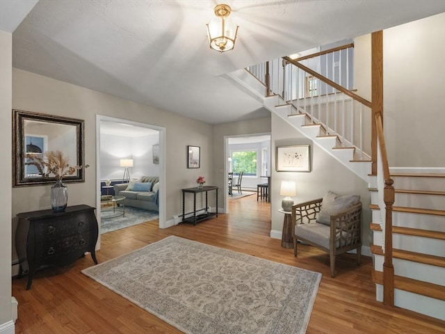 200 Newtown Rd, Acton, MA 01720 - entryway with stairway, wood finished floors, and a baseboard heating unit