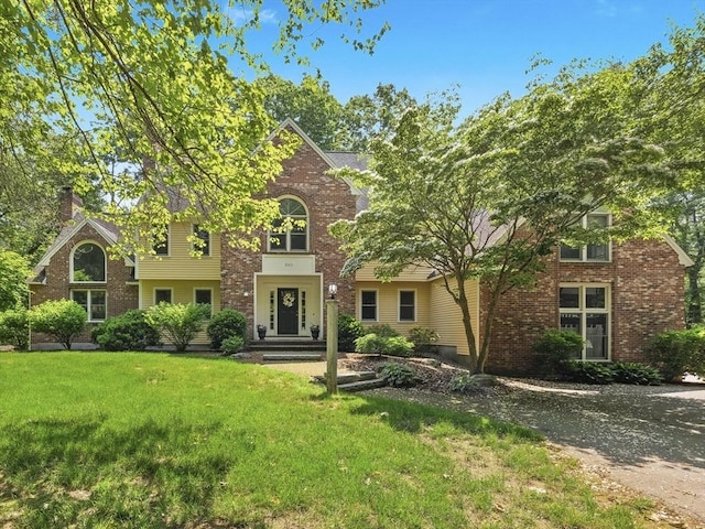 200 Newtown Rd, Acton, MA 01720 - view of front of home with a front lawn, brick siding, and a chimney