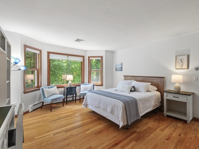 200 Newtown Rd, Acton, MA 01720 - bedroom featuring light wood-style flooring and a baseboard radiator