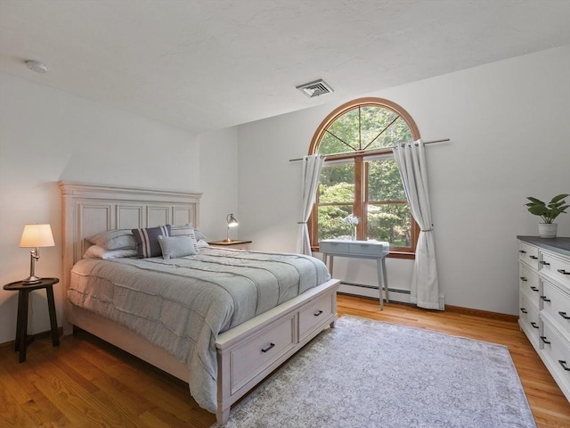 200 Newtown Rd, Acton, MA 01720 - bedroom featuring light wood-type flooring and baseboard heating