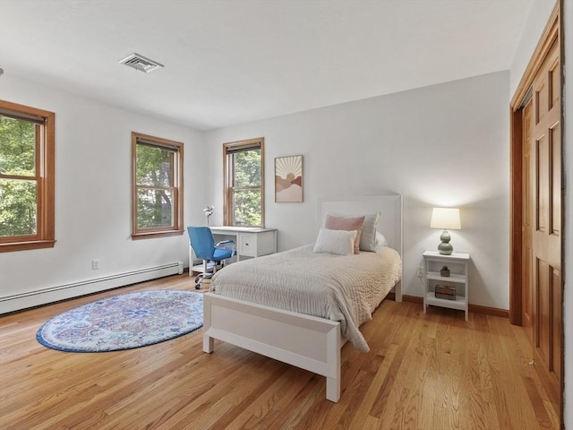 200 Newtown Rd, Acton, MA 01720 - bedroom with multiple windows, light wood-type flooring, and baseboard heating