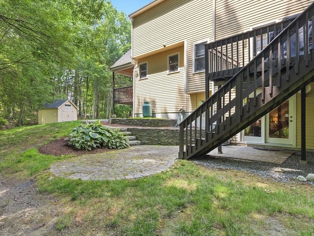 200 Newtown Rd, Acton, MA 01720 - view of home's exterior with a storage unit, stairway, a patio area, and a wooden deck