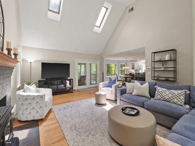 200 Newtown Rd, Acton, MA 01720 - living room with a skylight, high vaulted ceiling, a brick fireplace, and wood finished floors