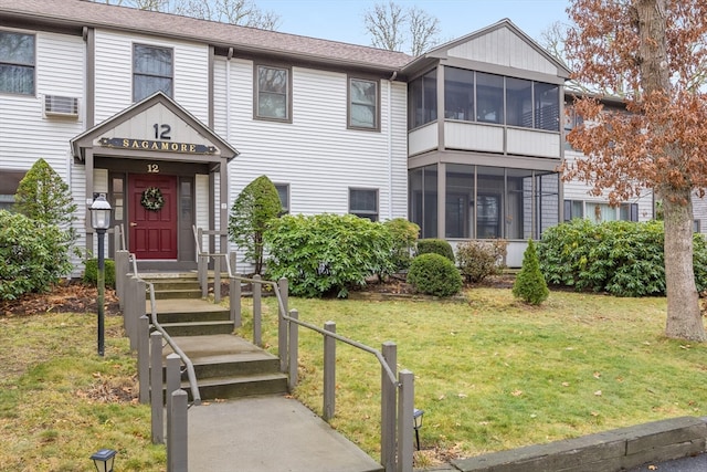 view of front of home featuring a front lawn and a sunroom