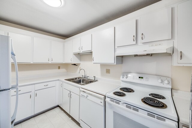 kitchen with white appliances, white cabinetry, and sink