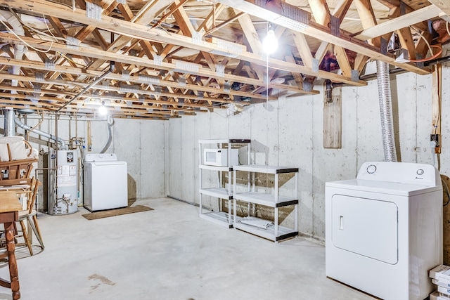 basement with water heater and washer and clothes dryer