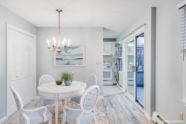 dining space featuring a notable chandelier, light hardwood / wood-style floors, and baseboard heating